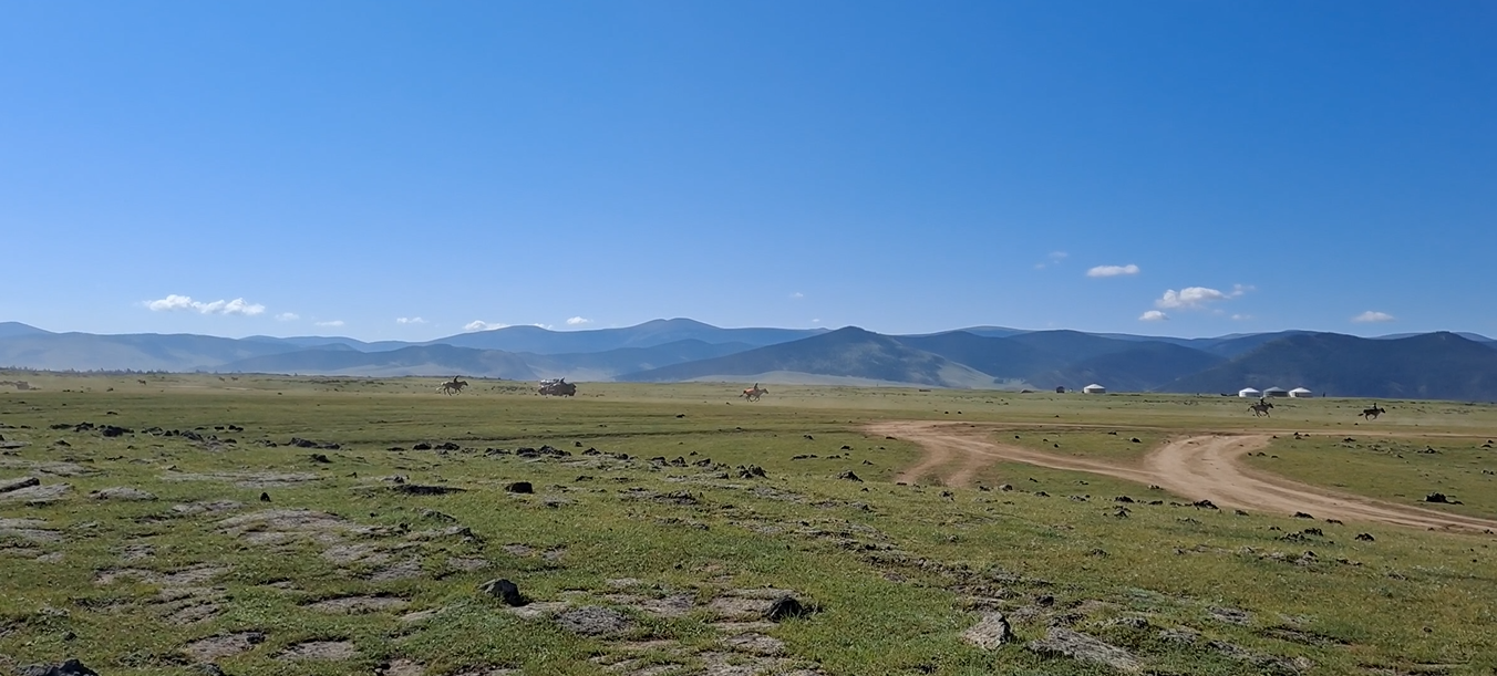 Child horse racers galloping on the open steppe